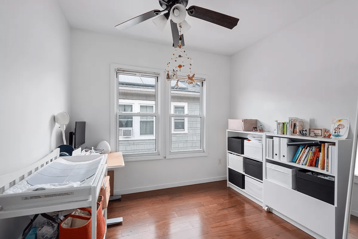 bedroom with ceiling fan and white walls