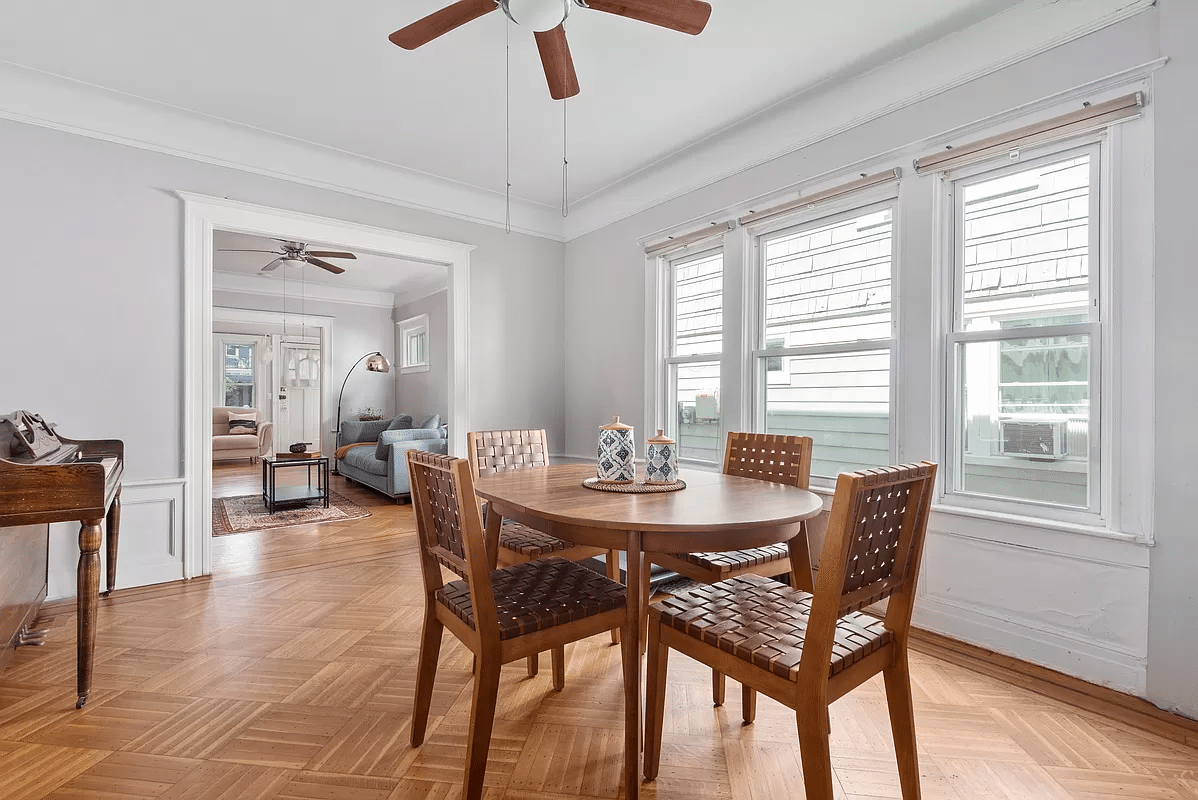 dining room with ceiling fan, view of living room