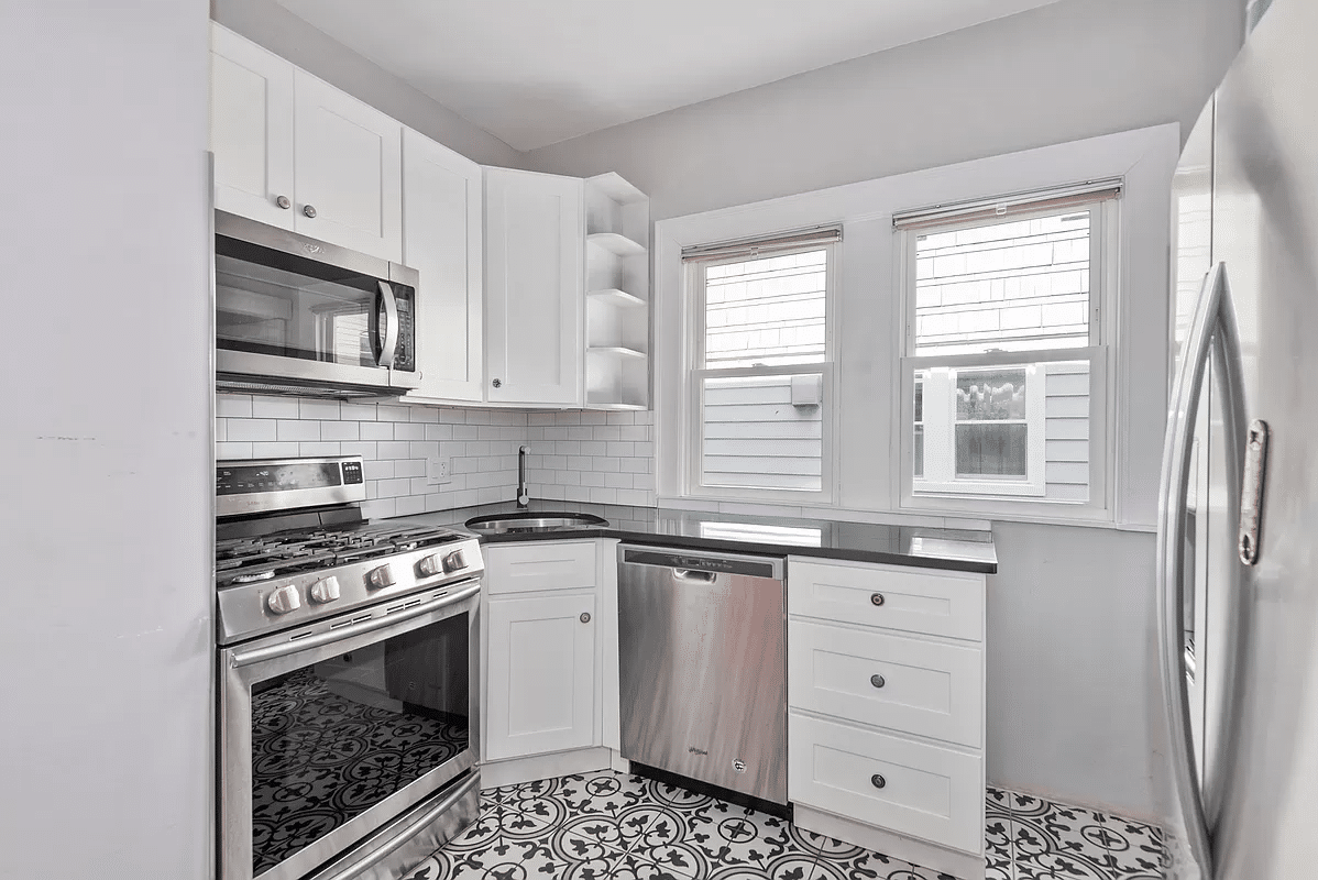 kitchen with graphic tiles and white cabinets