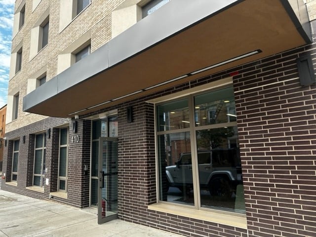 dark brown brick entry with glass doors