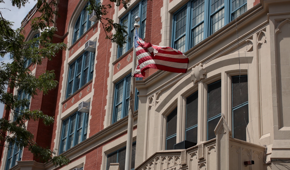 brooklyn education - flag waving in front of a school