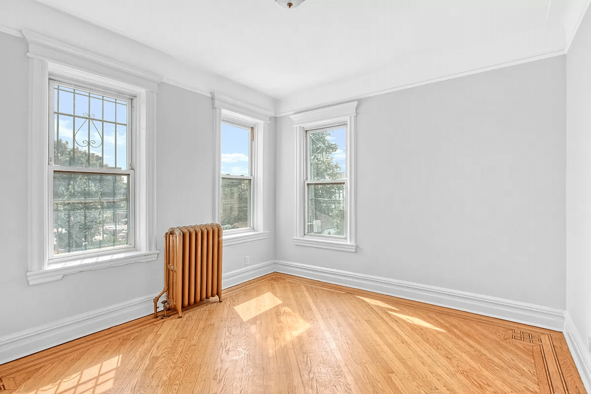 bedroom with wood floor, two exposures