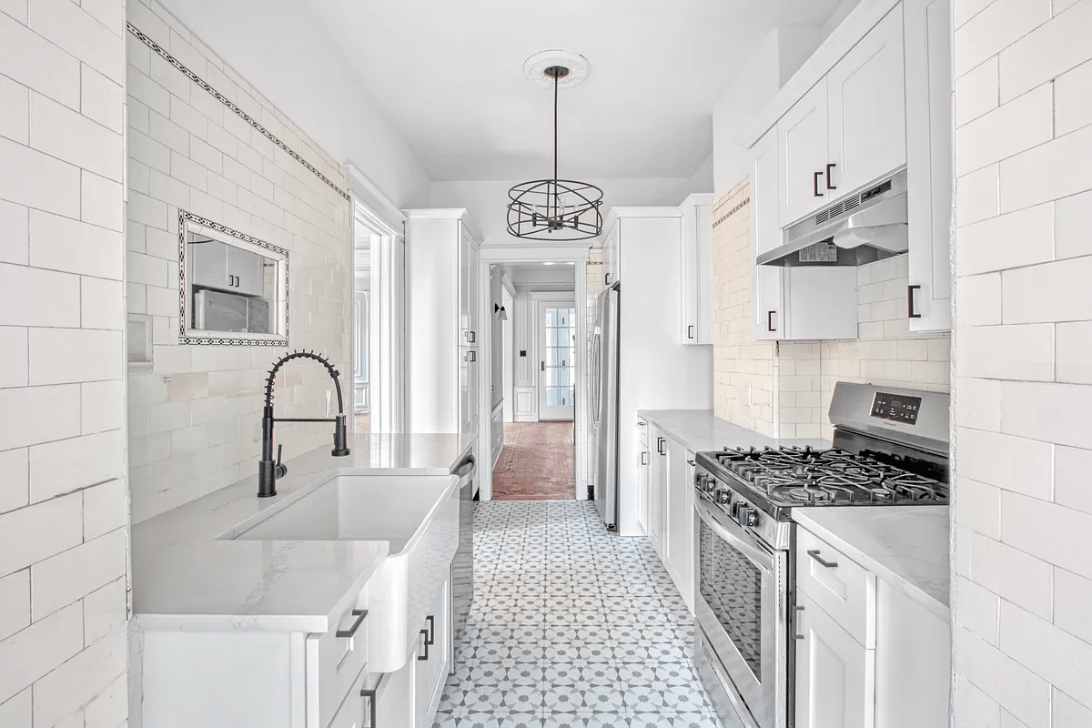 kitchen with white cabinets, apron front sink