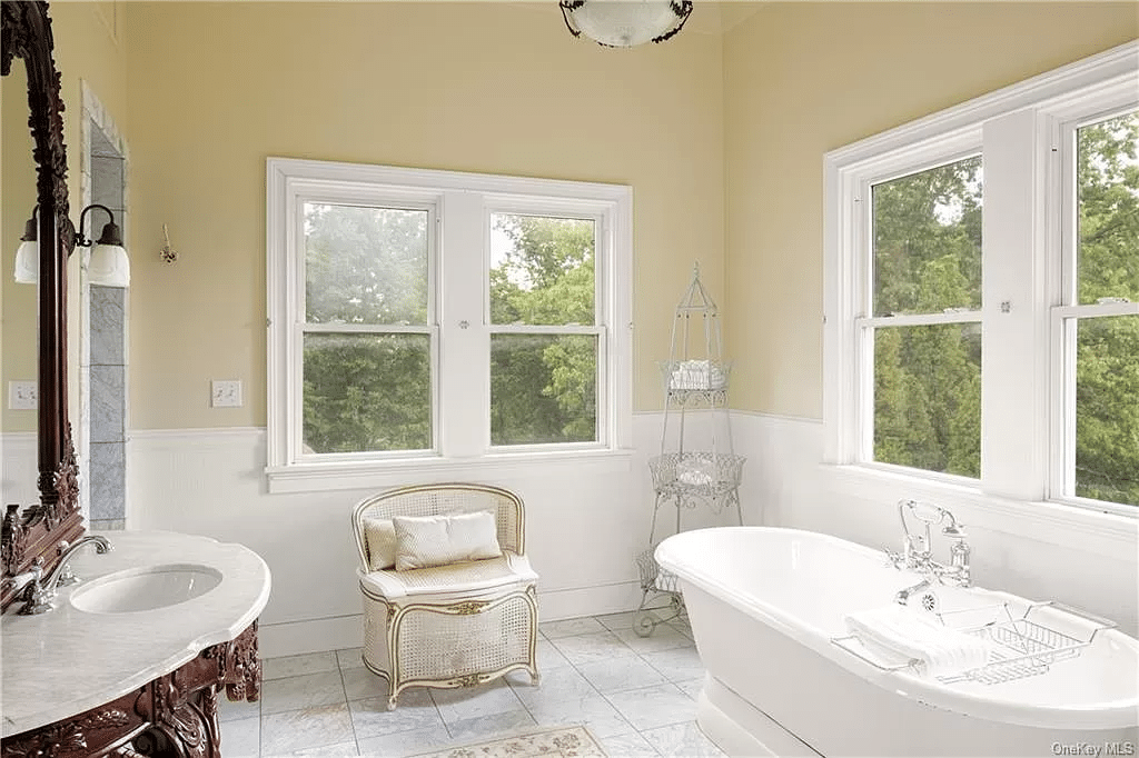 bathroom with pedestal tub, two exposures