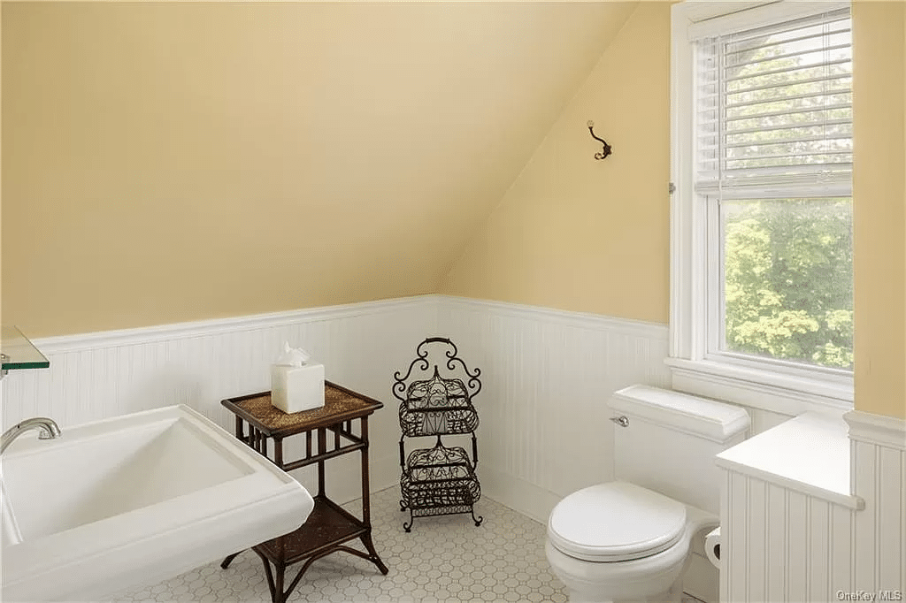 bathroom with white floor tile, beadboard on walls