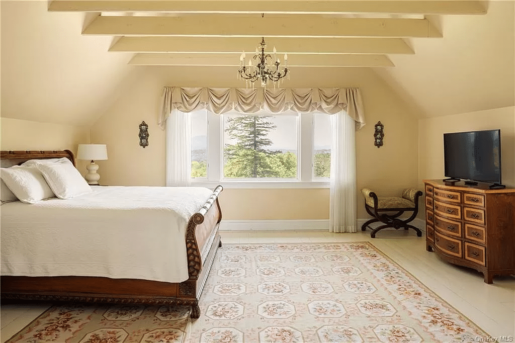 bedroom with painted wood floor, exposed beams