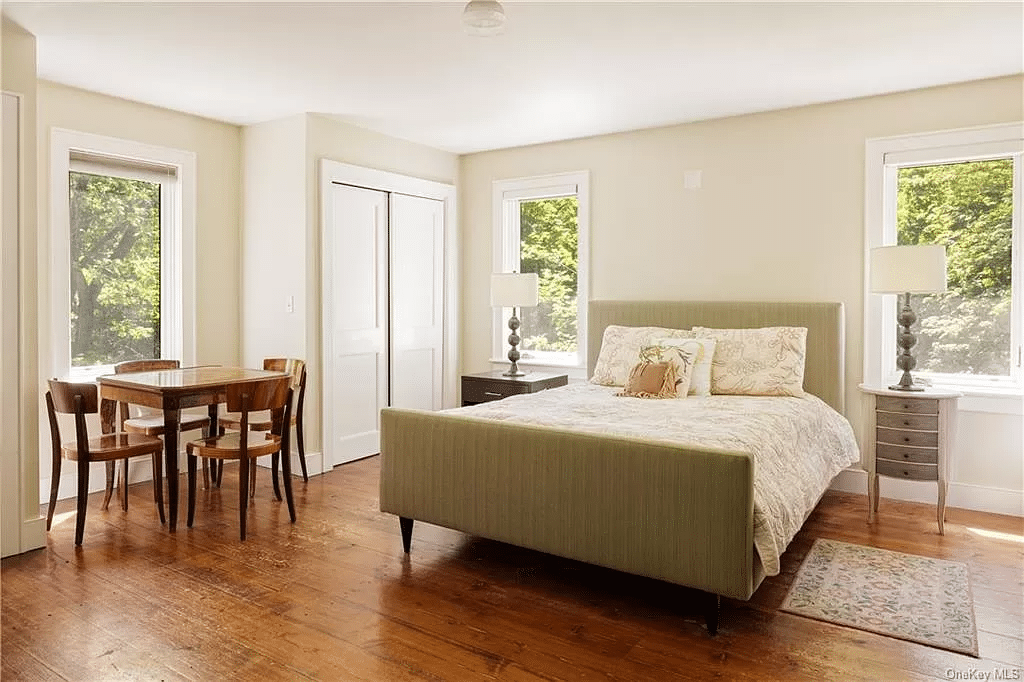 guest cottage bedroom with wood floors, two exposures