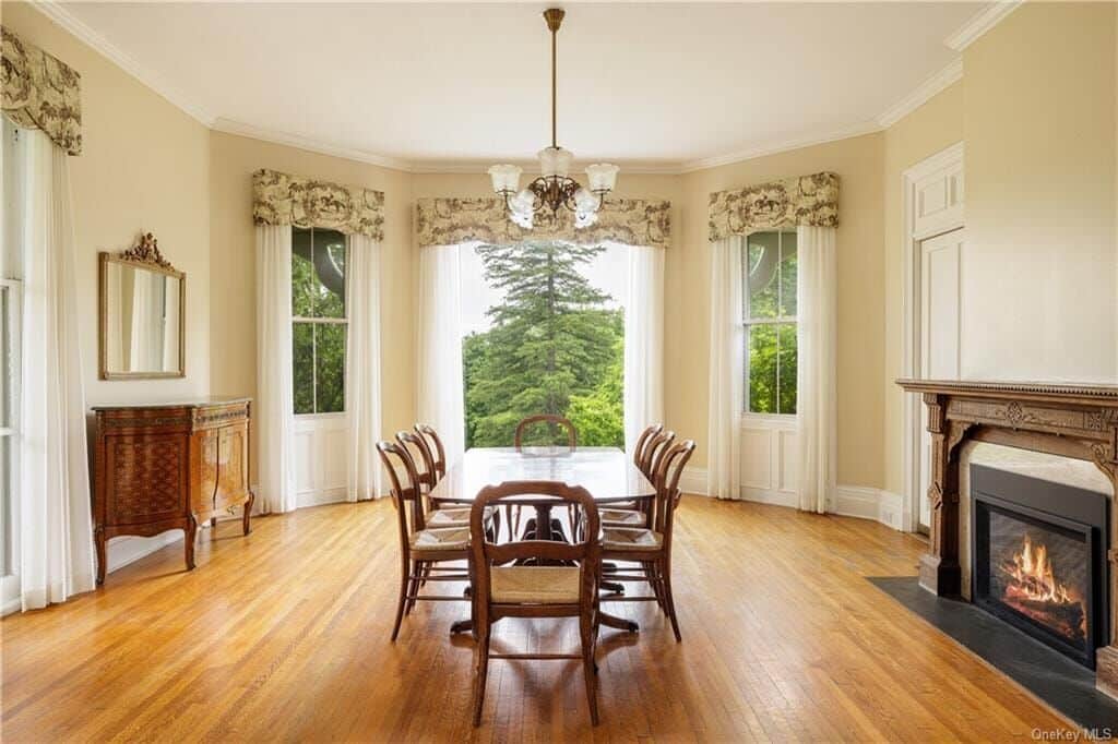 dining room with mantel and wood floors