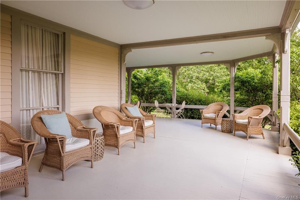 wraparound porch with wicker furniture