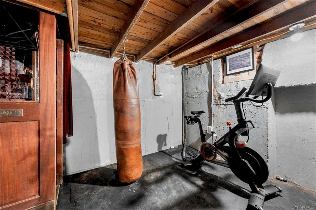 basement with corner set up as a gym