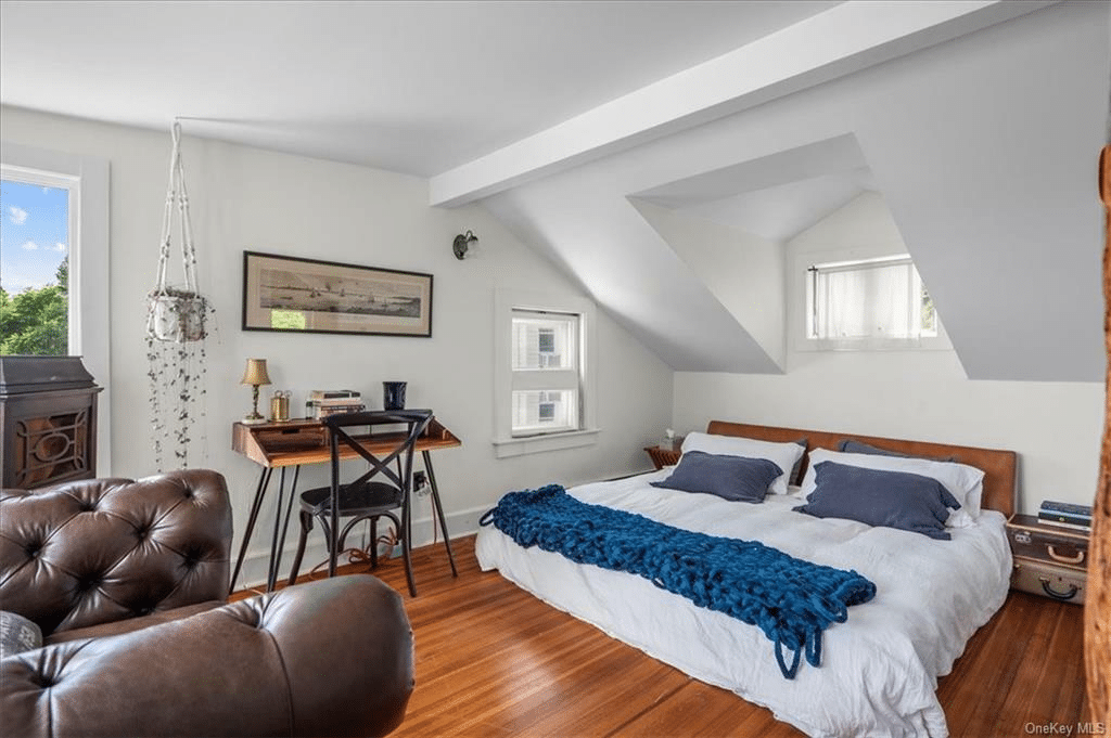 bedroom with wood floor, two exposures