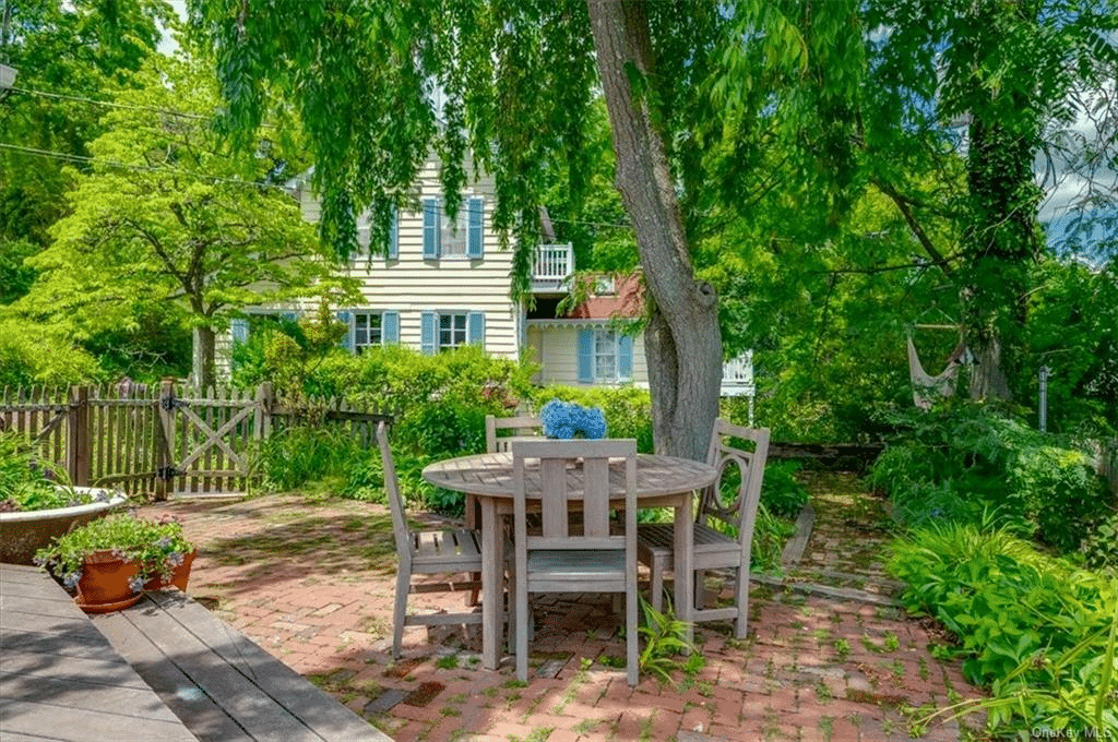 a brick paved patio with room for dining