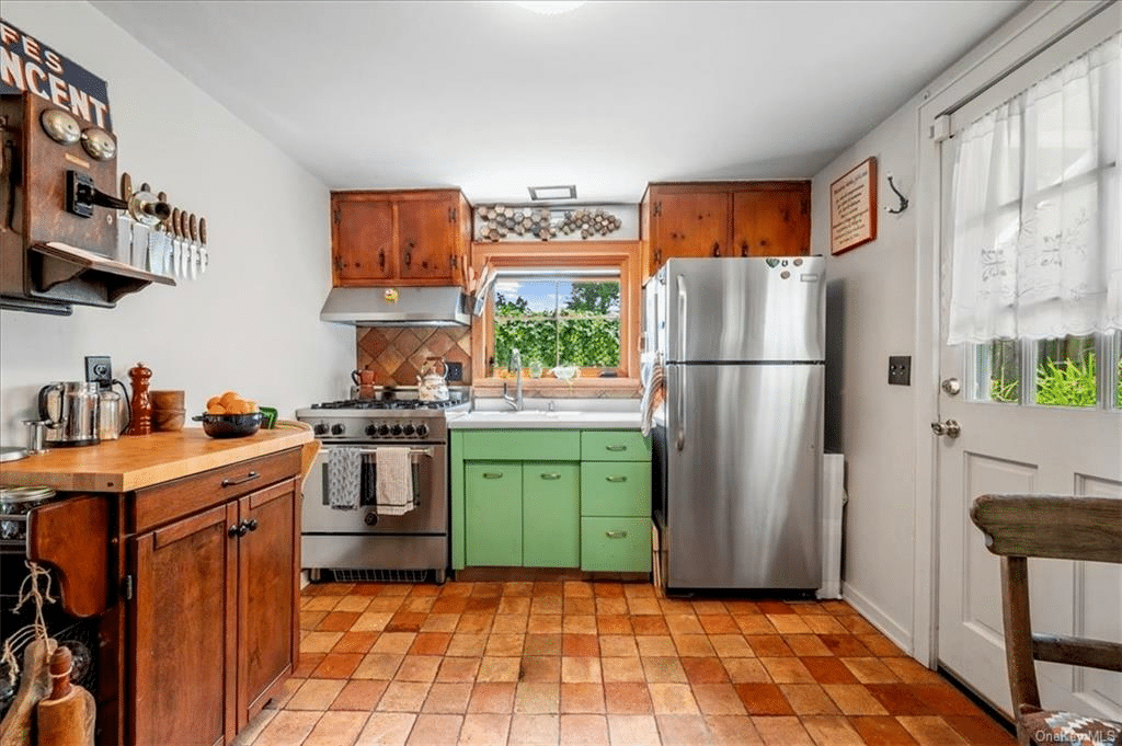 kitchen with terra cotta tile floor and door to outside