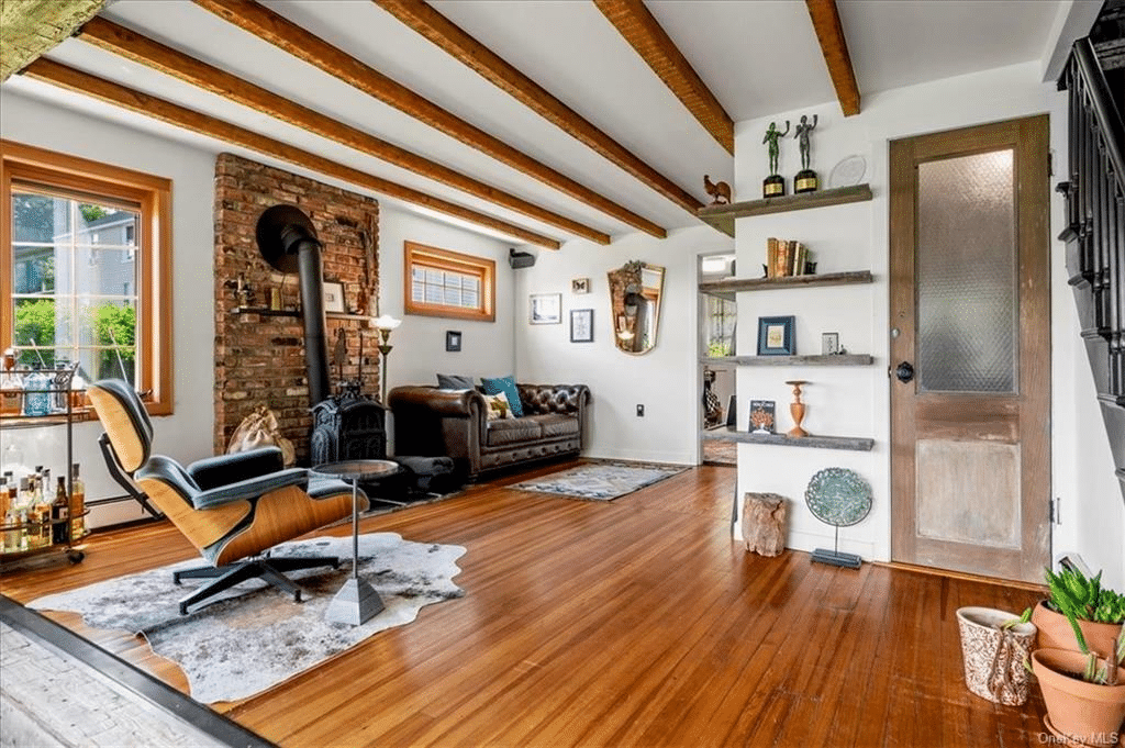 living room with wood floor, beamed ceiling