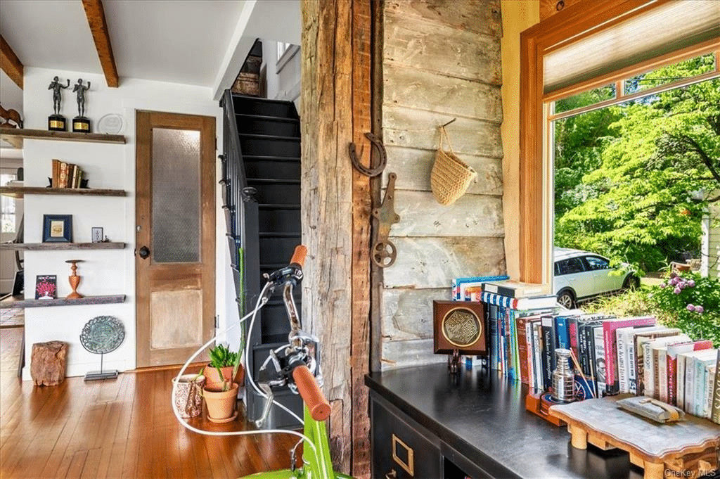 entry with room for a desk and a staircase painted black