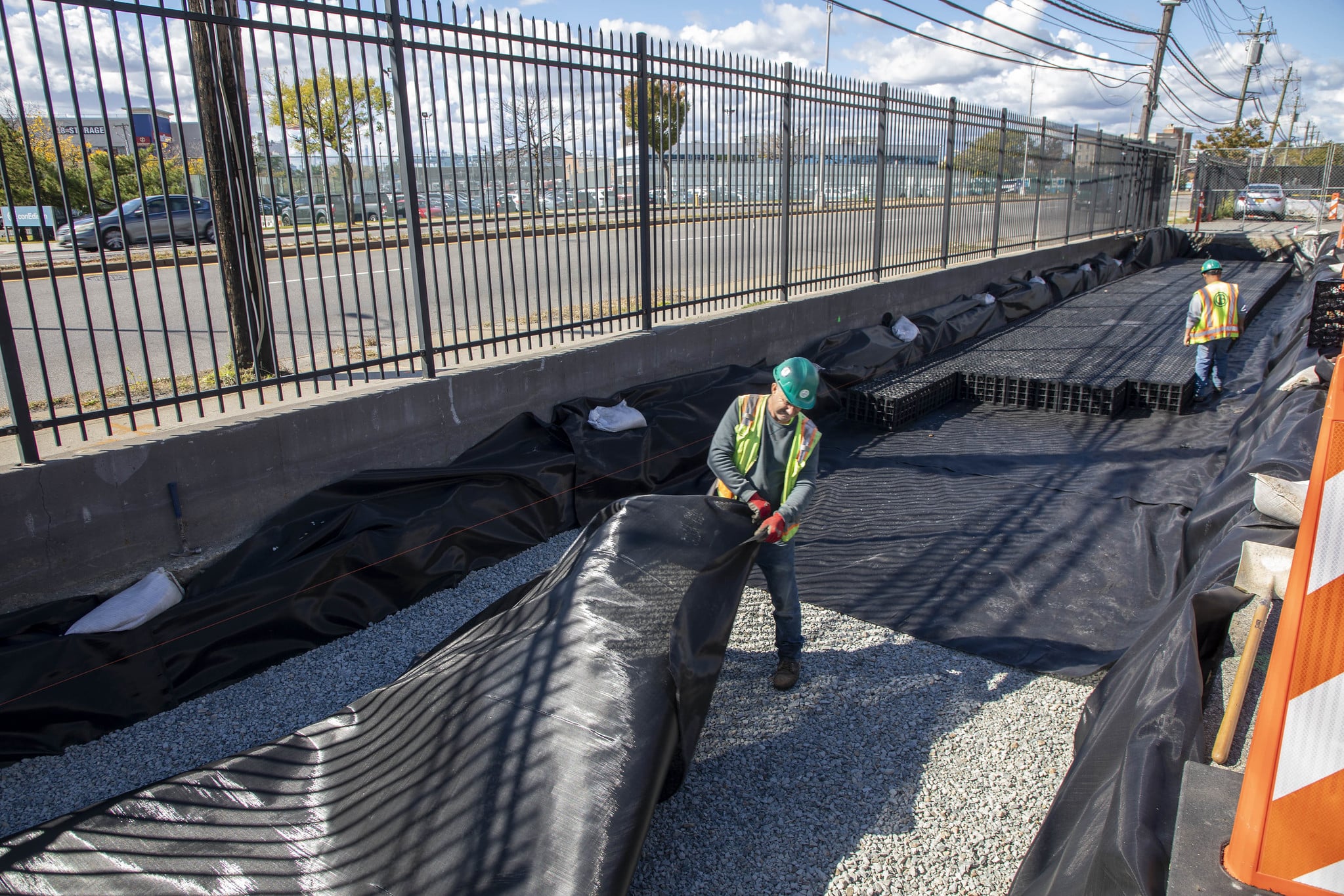 workers installing drainage material