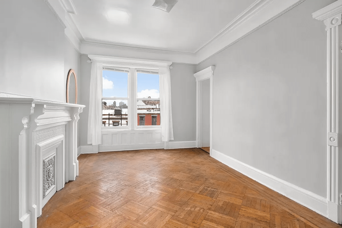 bedroom with white painted woodwork and mantel