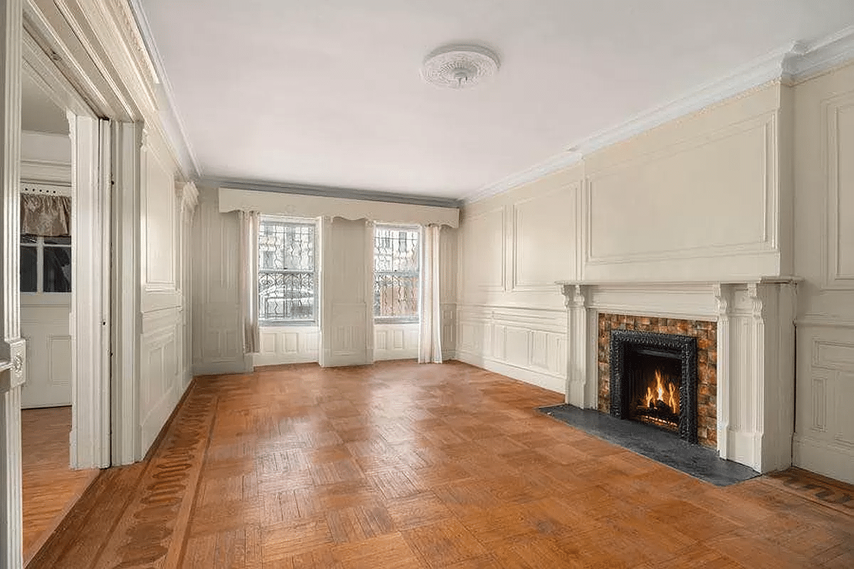 dining room on garden level with wainscoting, molding, mantel