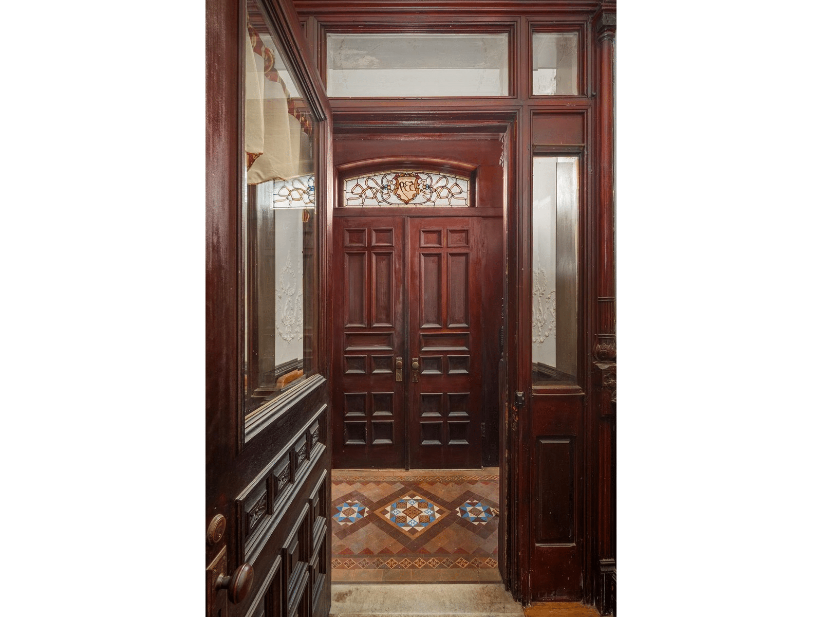 entry with colorful encaustic tile flor