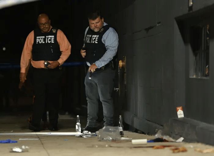 police aim flashlights at sidewalk