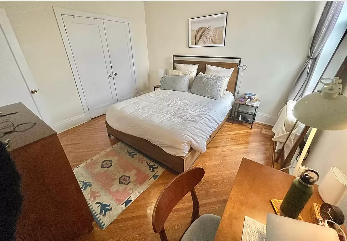 bedroom with wood floor, picture rail