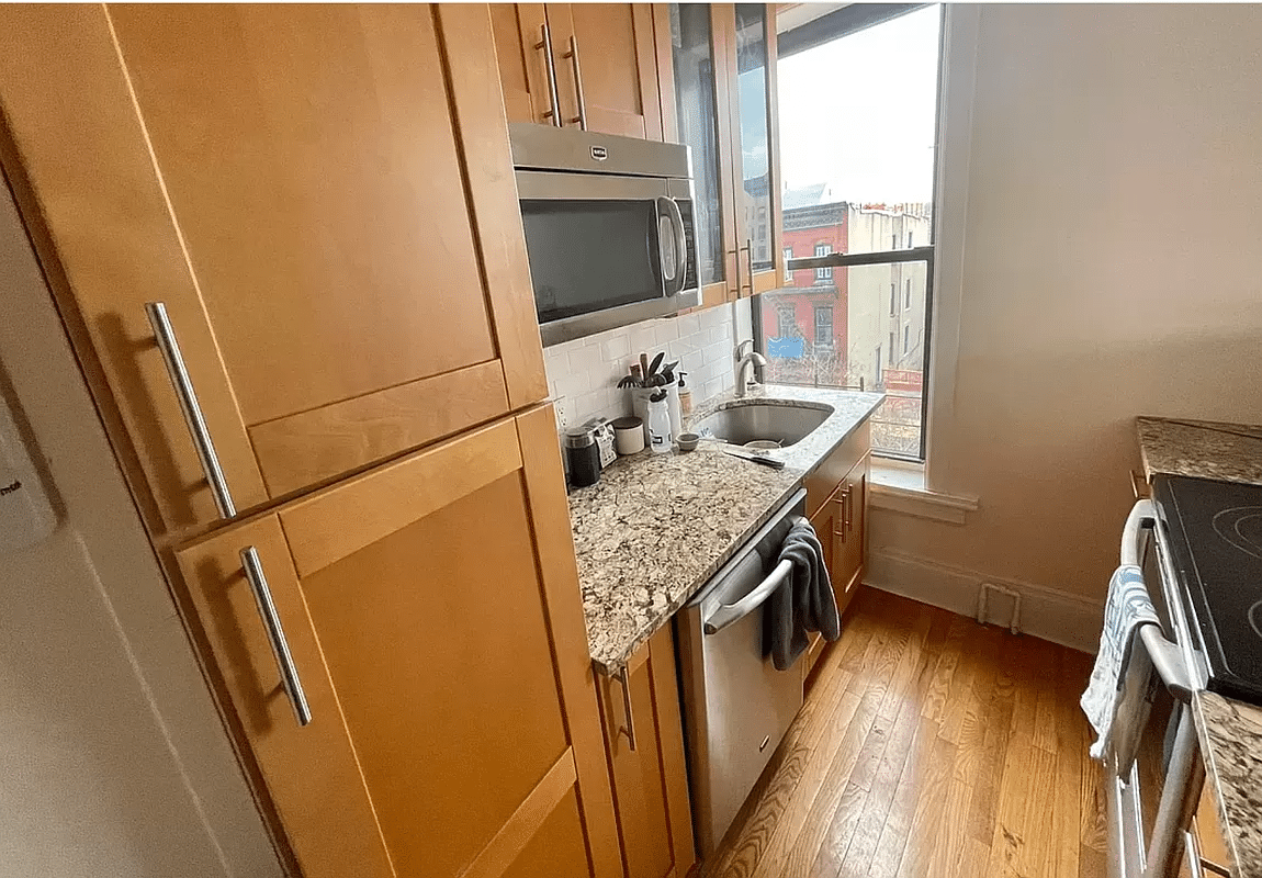 windowed kitchen with dishwasher, wood cabinets