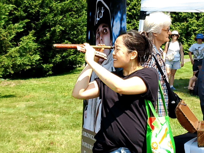 The event was full of hands-on learning experiences. One attendee checks out a gun site with dated trinkets