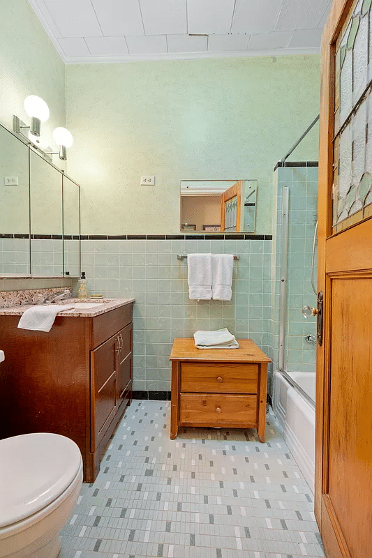 Bathroom with wall and floor tiles in vintage green