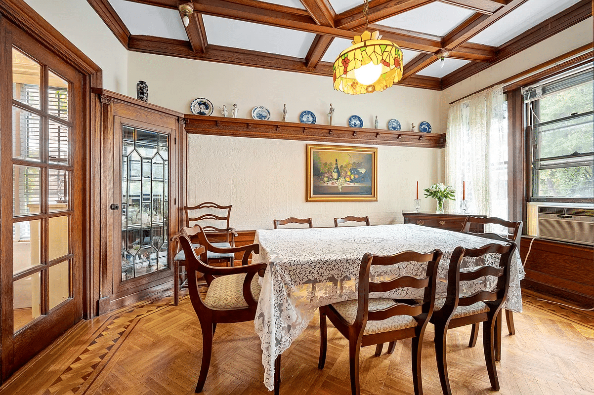 dining room with corner cabinets, plate shelf, coffered ceiling