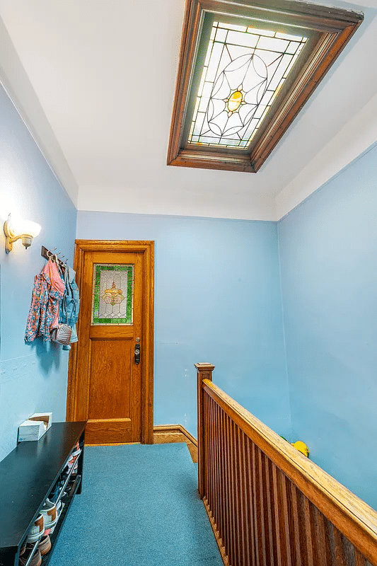 Upper floor hallway with stained glass skylight, carpet