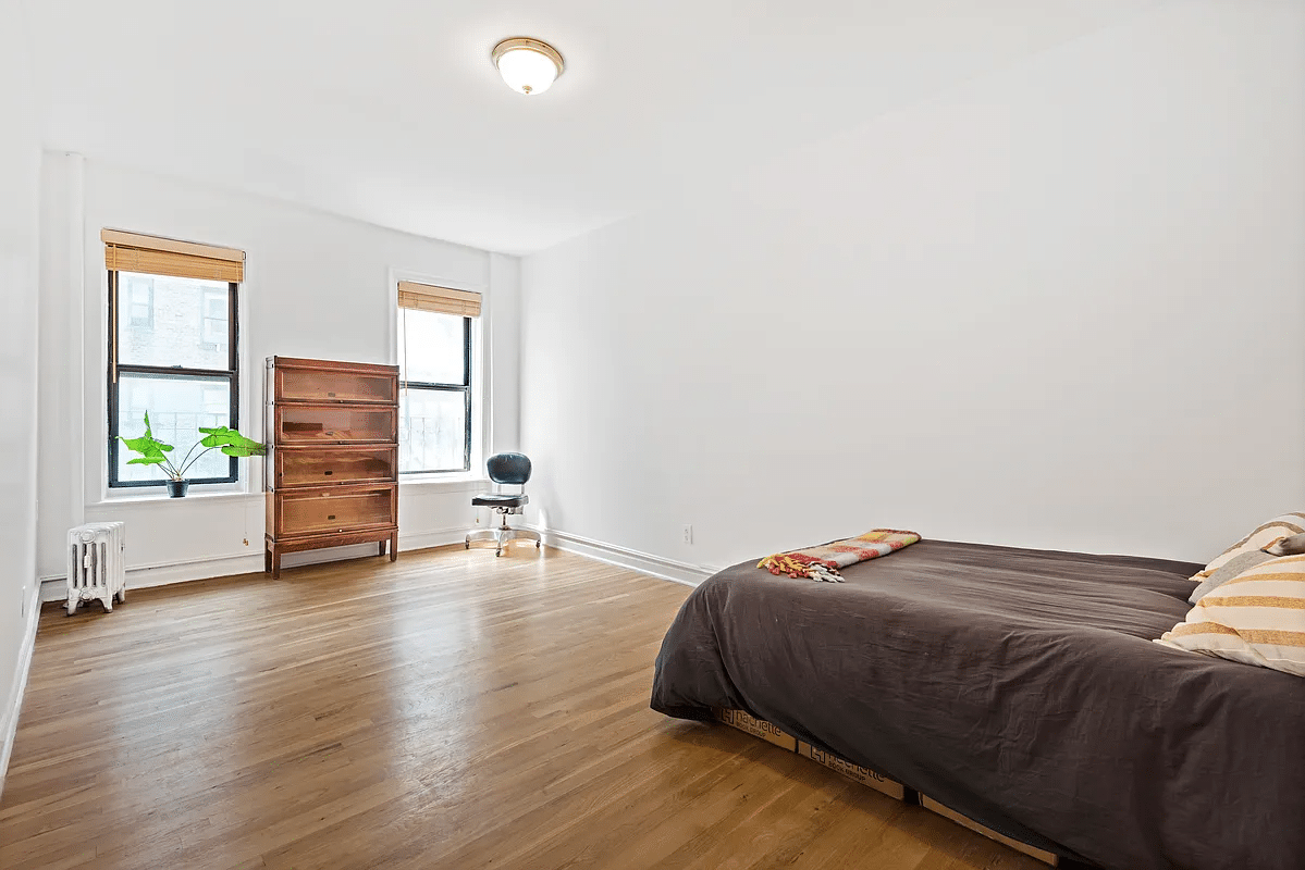 bedroom with wood floor, white walls