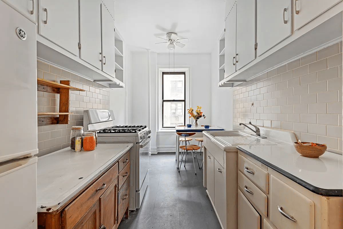 kitchen with vintage cabinets, vintage porcelain sink, and a dining nook