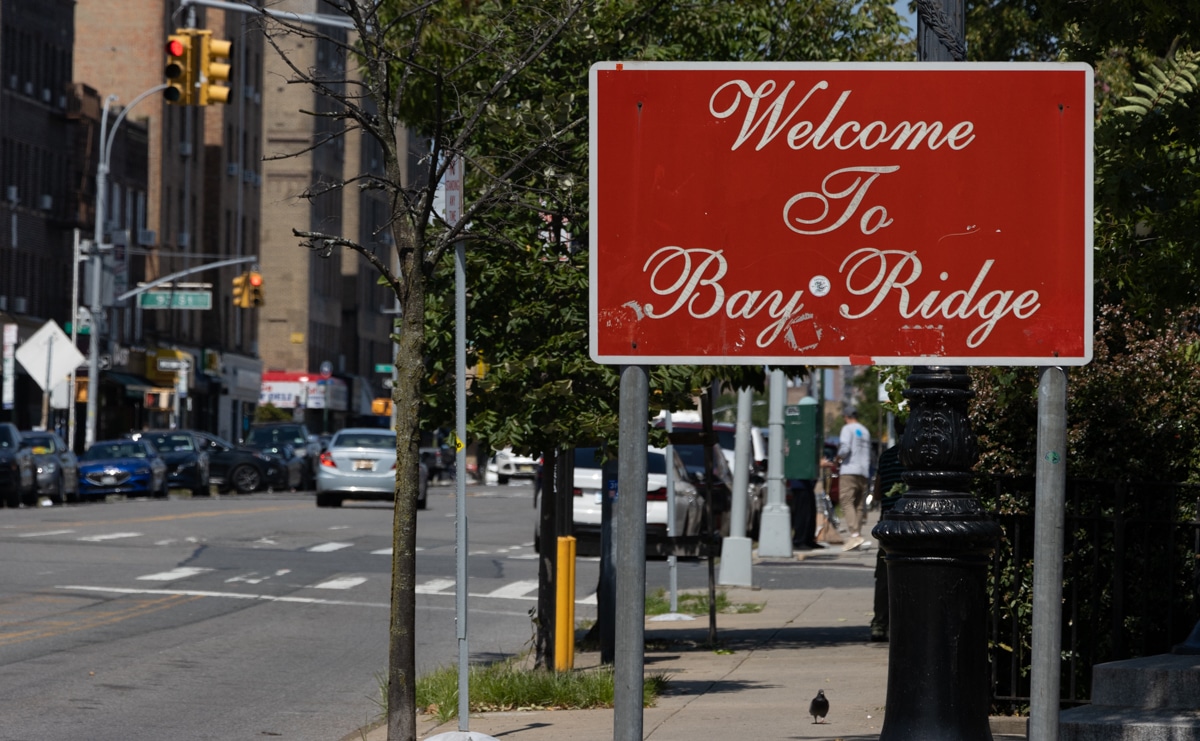 brooklyn - a red welcome to bay ridge sign