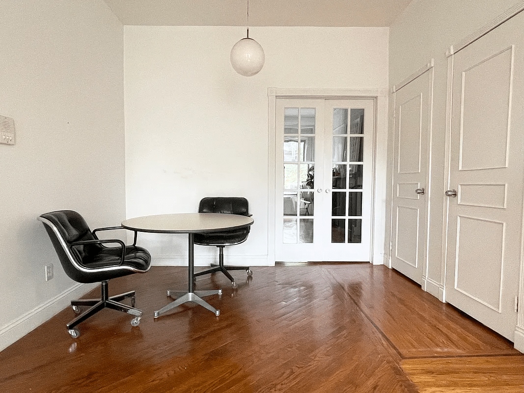 dining area with pendant light, wood floor, french doors