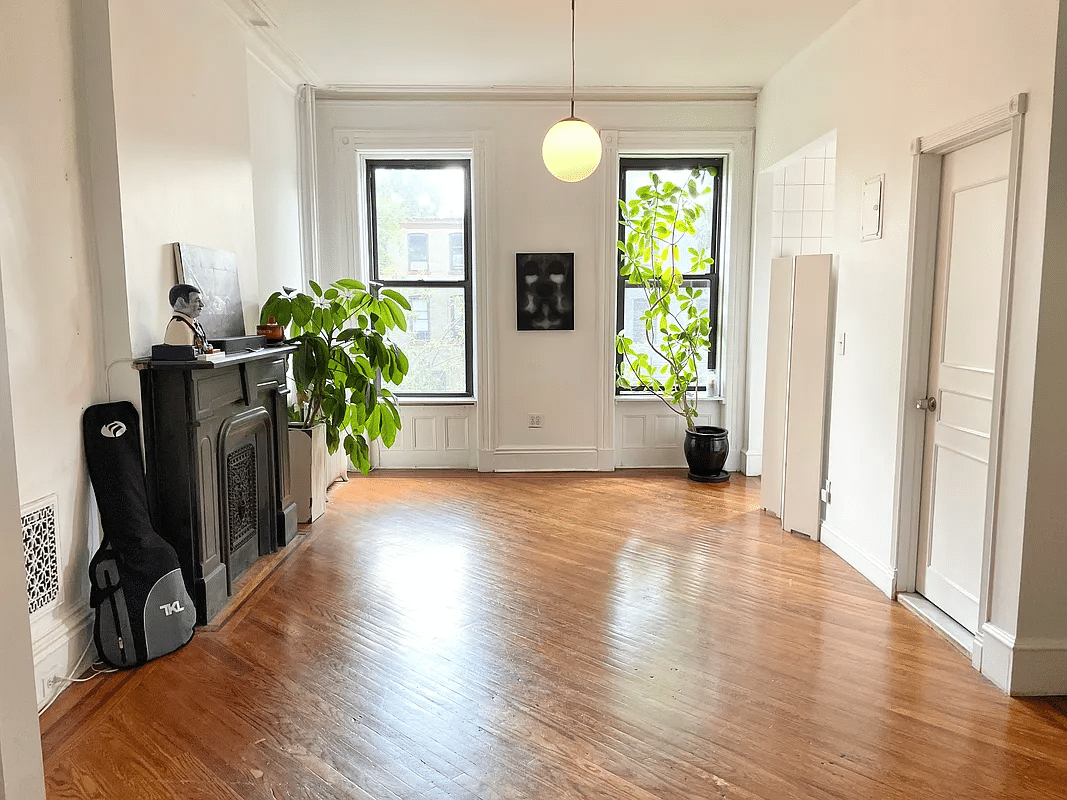 bed stuy - living room with wood floor, mantel