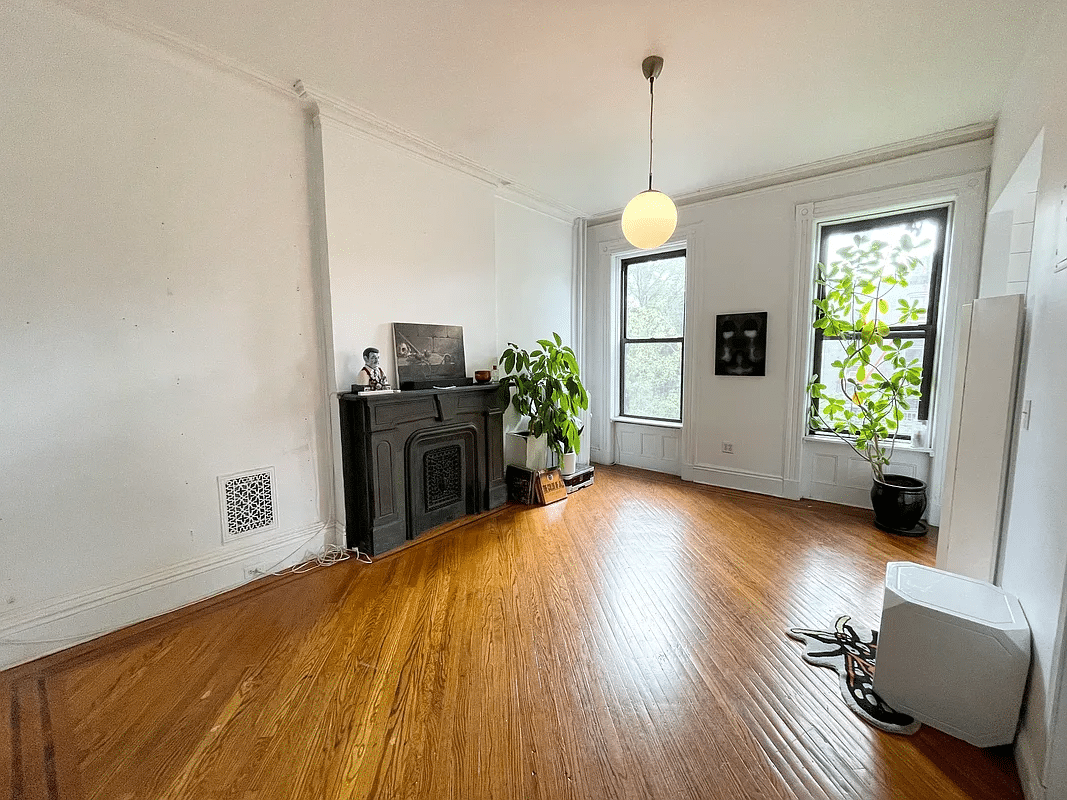 bed stuy - living room with wood floor, mantel