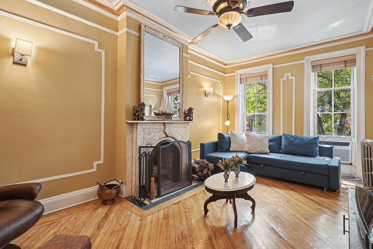 parlor with wall moldings, wood floor