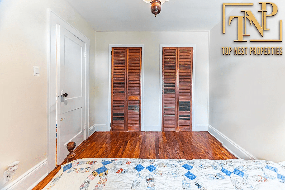 bedroom with wood floor, two closets