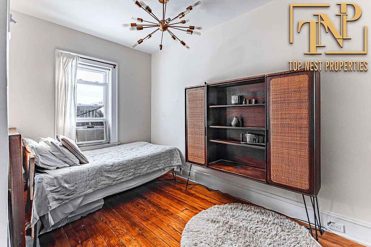 Bedroom with wooden floor, one window