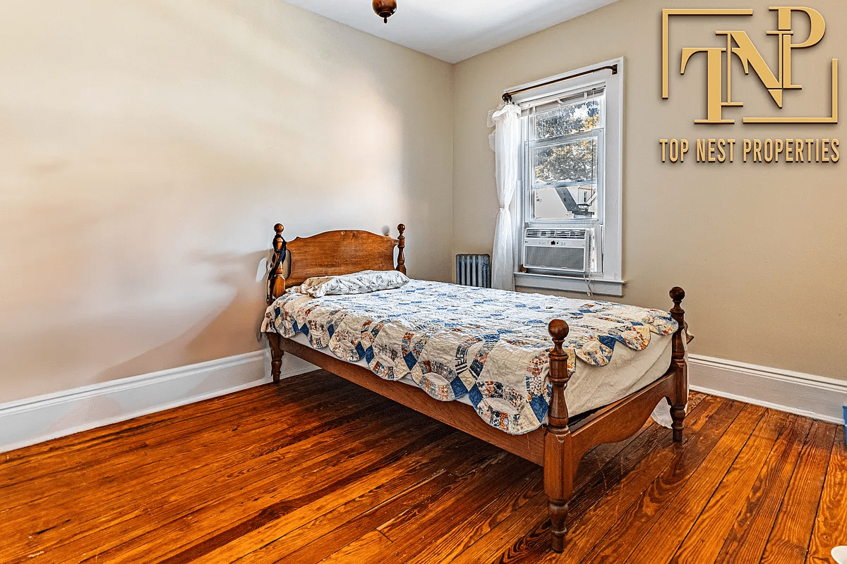 bedroom with wood floor, one window