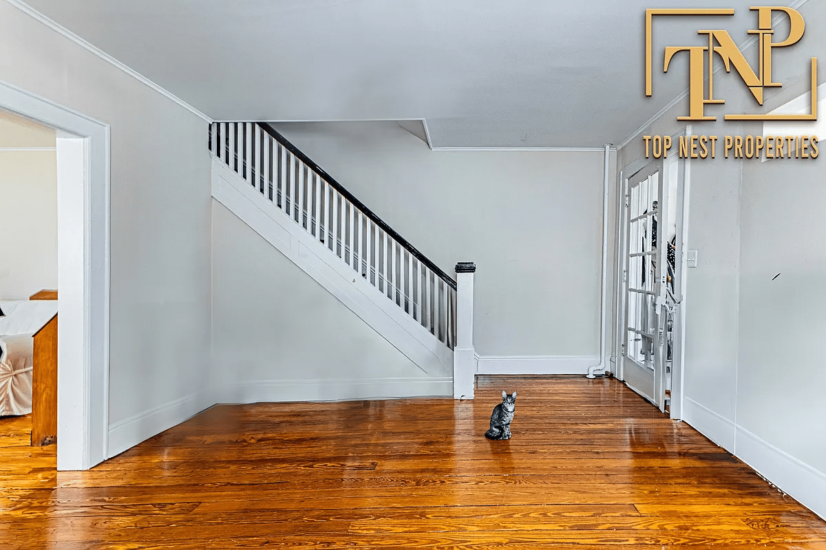 Living room with wooden floor, stairs and a virtual cat added