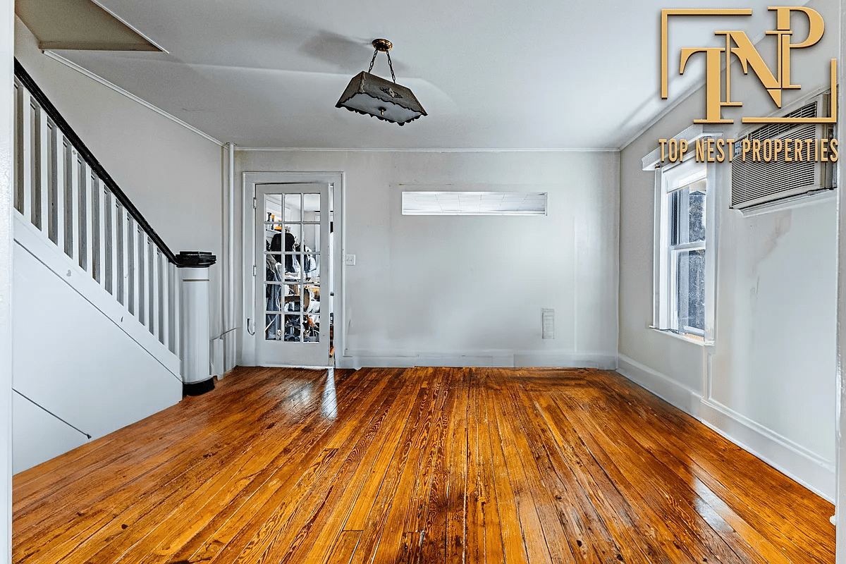 living room with wood floor, stair and cut out to the sun room