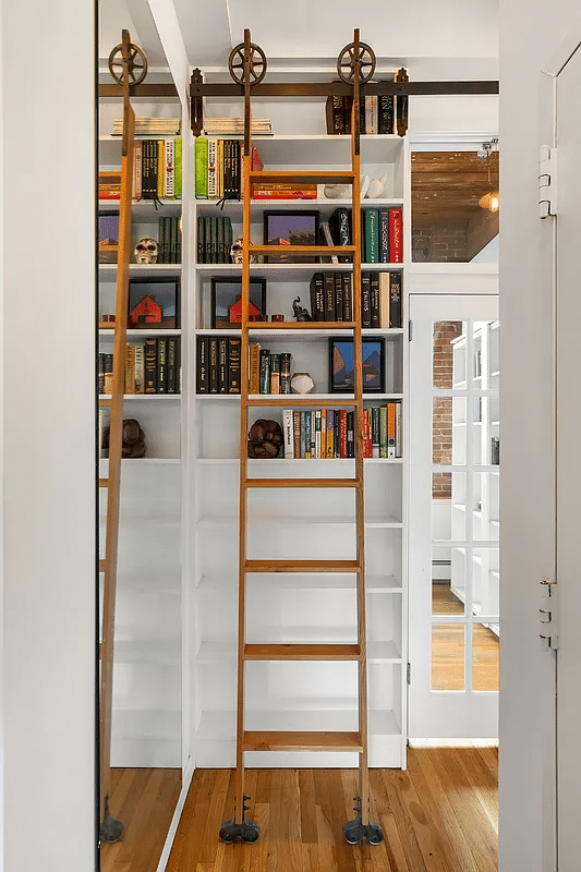 Library ladder against bookshelves in the hallway