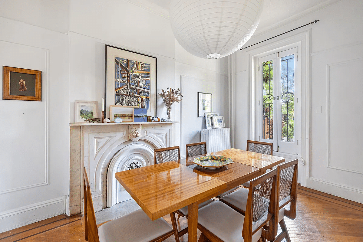 Dining room with marble fireplace, wooden floor