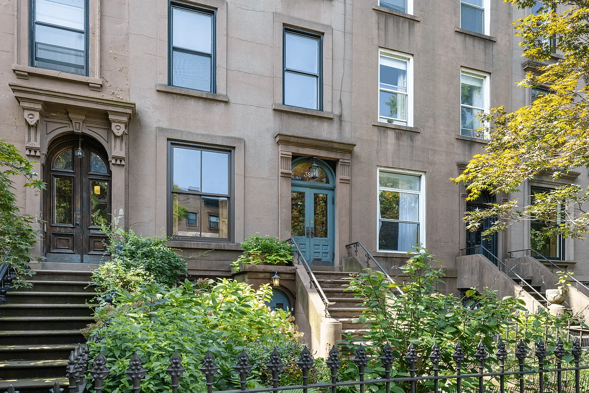 Brownstone exterior with porch and front yard