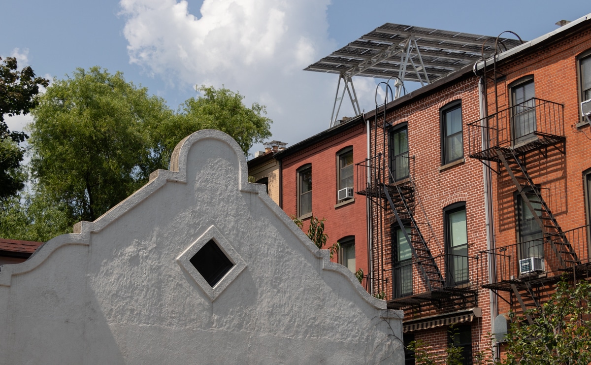 brooklyn - brick rowhouses, one with solar panels