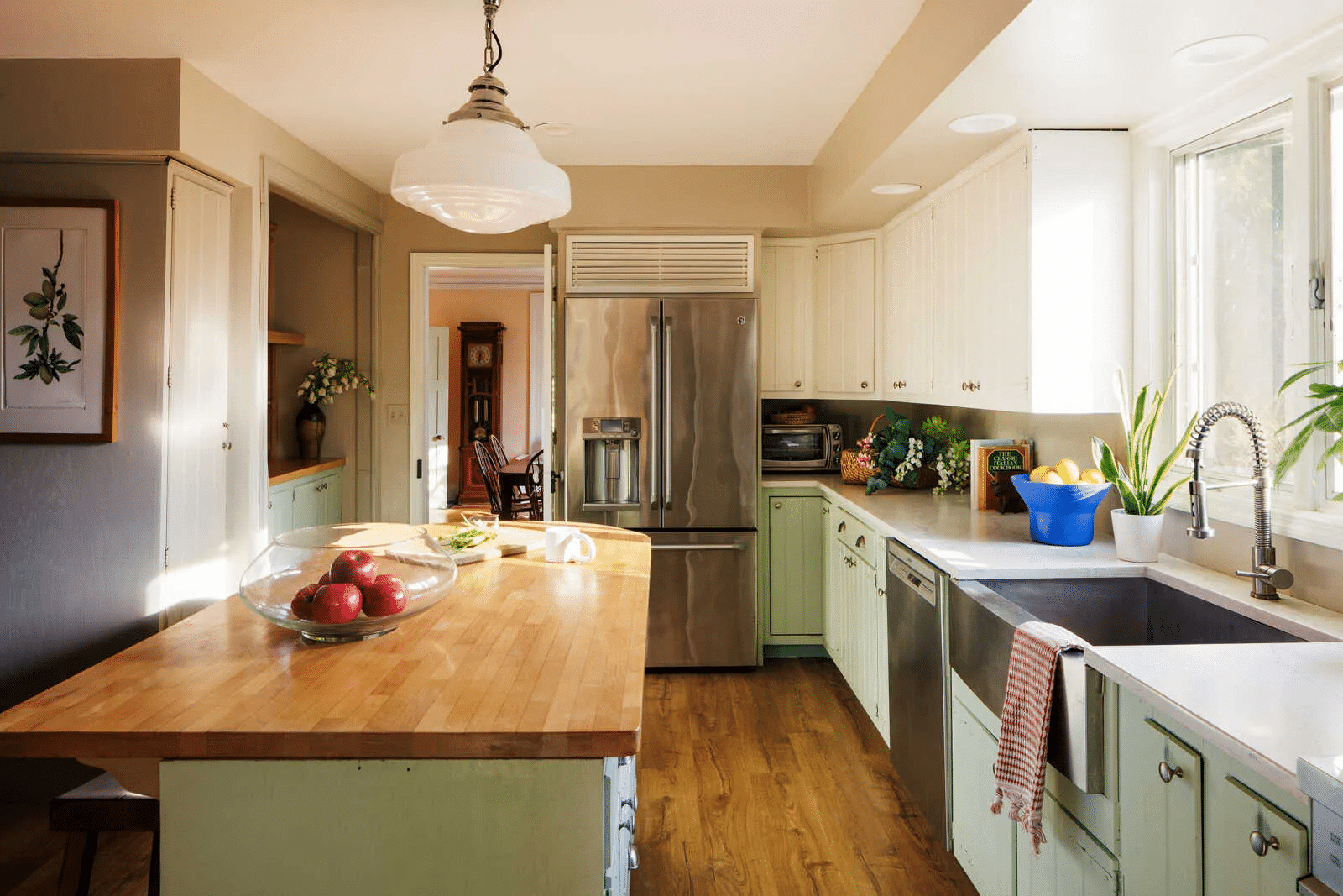 kitchen with pale green lower cabinets, cream uppers