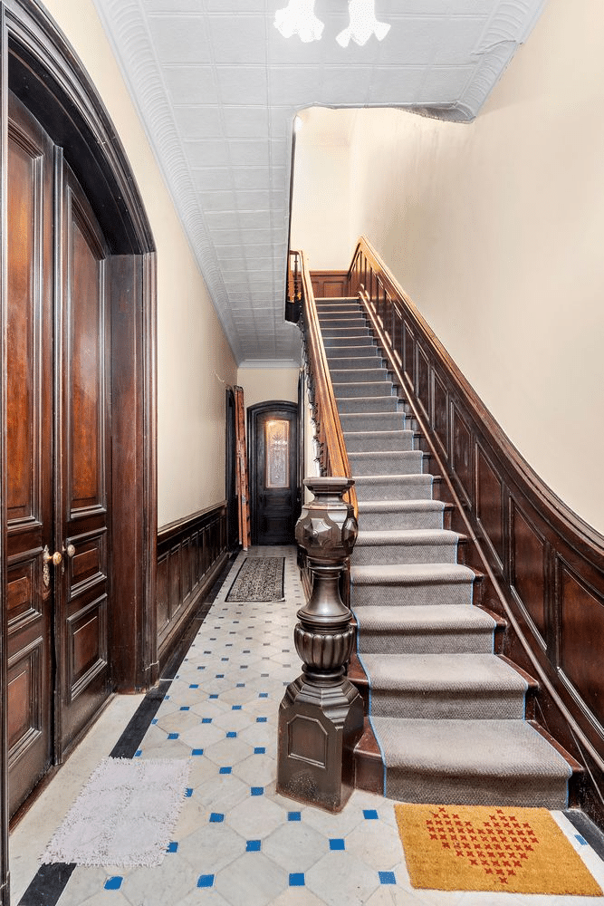 entry with tiled floor, stair with wainscoting