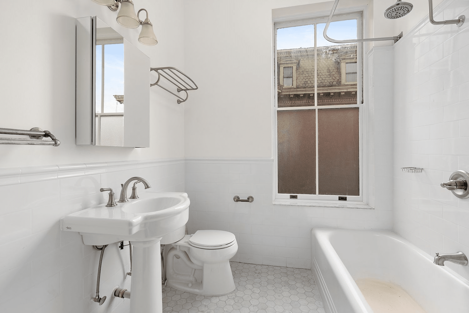 bathroom with white fixtures and tile