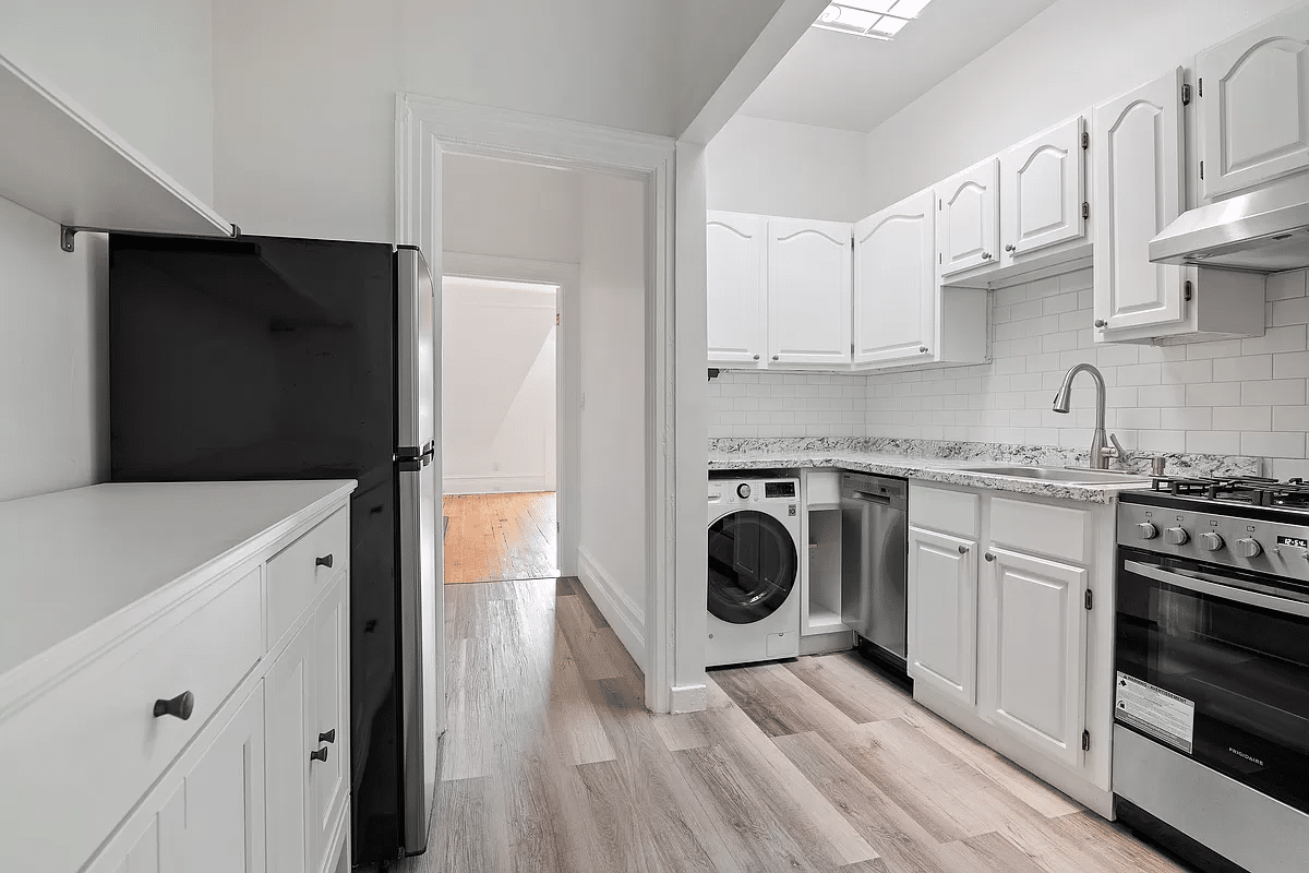 kitchen with white cabinets, a dishwasher, washing machine